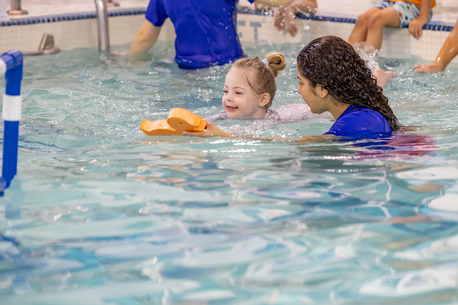 Tot practicing her kicks in the water